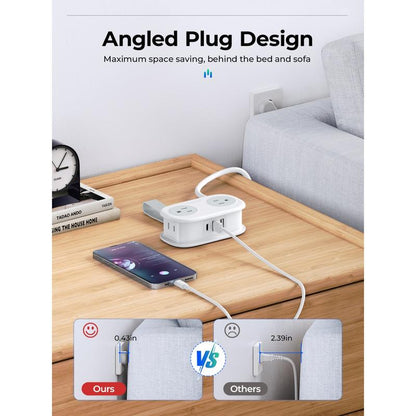 Power strip with angled plug design on a table next to a smartphone, with a sofa and clock in the background.